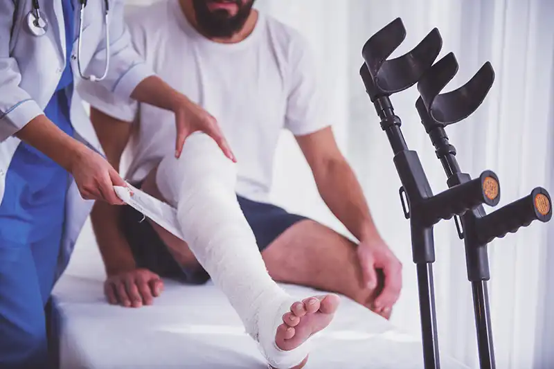 injured man with doctor at injury clinic