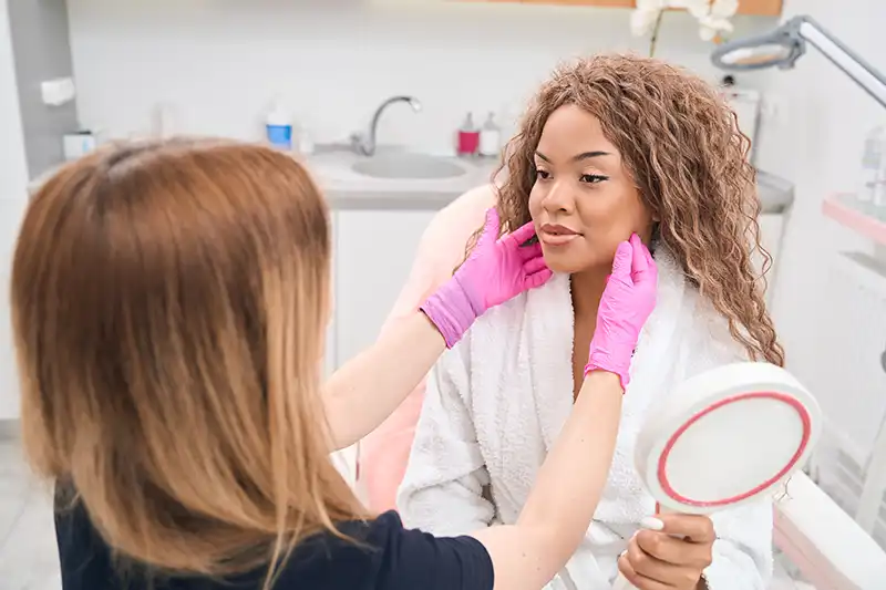 beautiful young woman getting a specialized care dermatology consultation